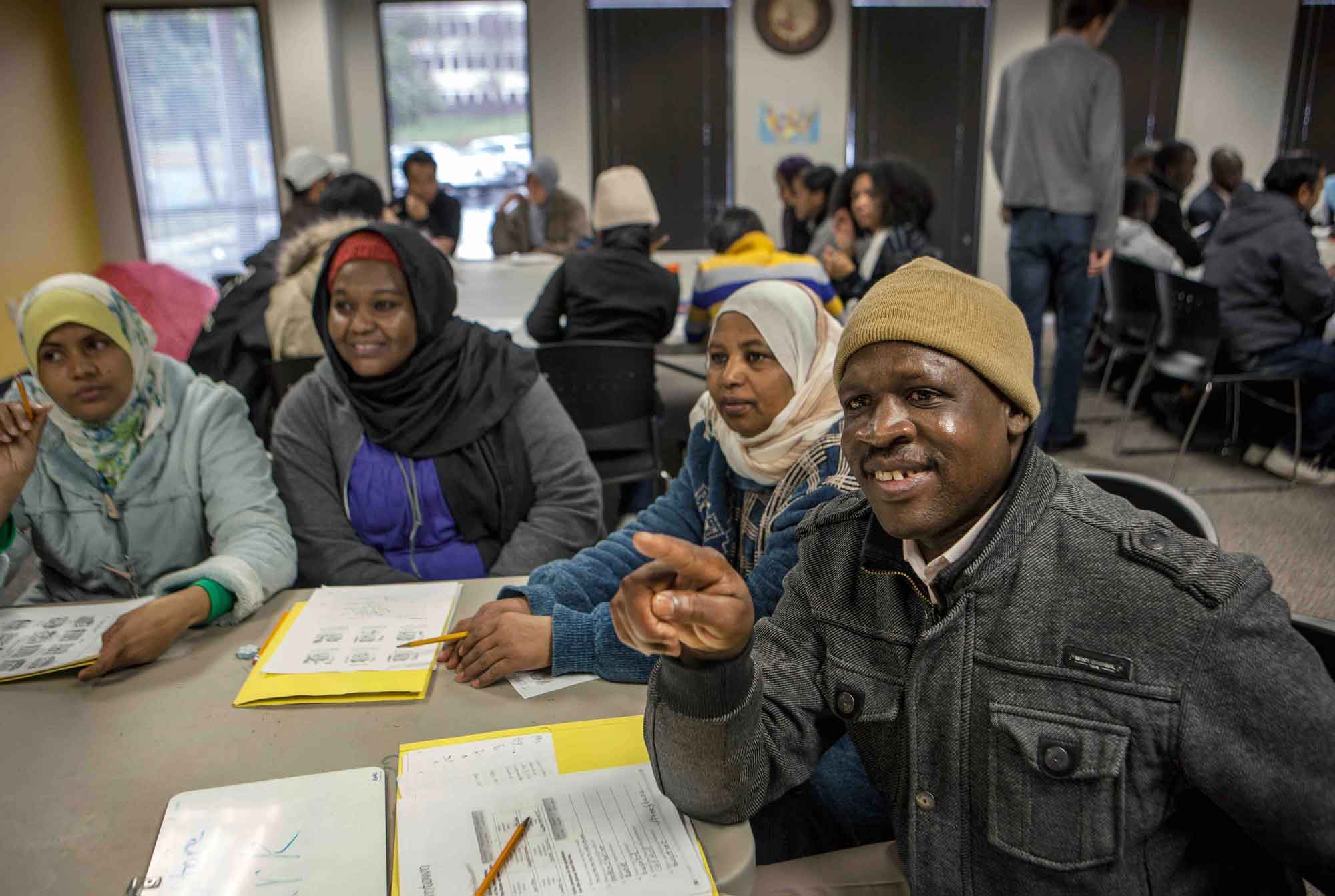 Recently resettled refugees learning English at their local resettlement agency